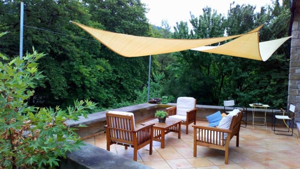 a patio with chairs and a table and a hammock at Pili Country House in Pili