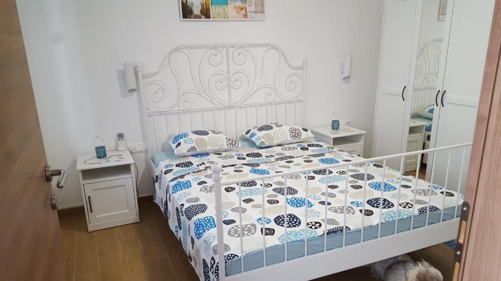 a bedroom with a bed with a blue and white comforter at Dora in Njivice