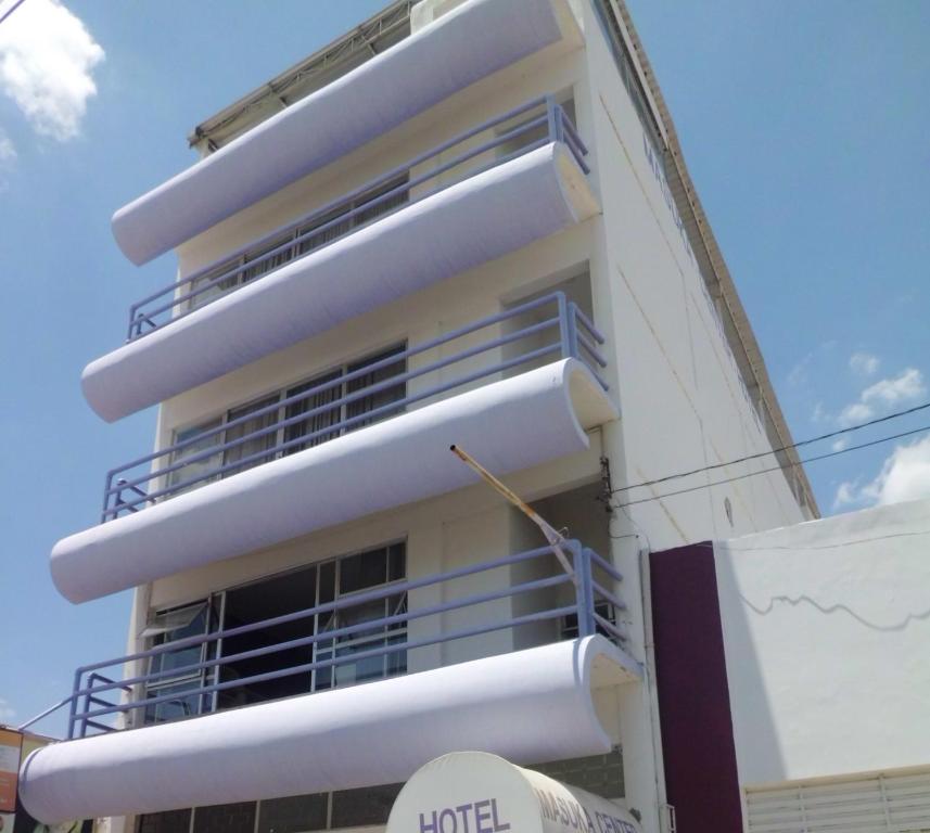 a white building with balconies on the side of it at Masuka Center Hotel in Petrolina