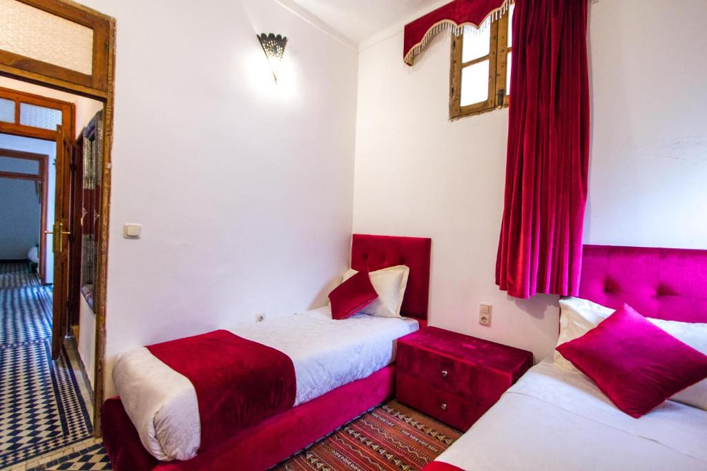 Postel nebo postele na pokoji v ubytování Riad Dar Bab Guissa