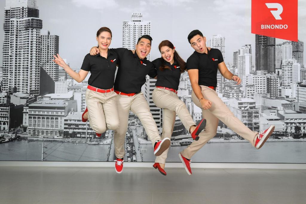 a group of people jumping in the air at Red Planet Manila Binondo in Manila