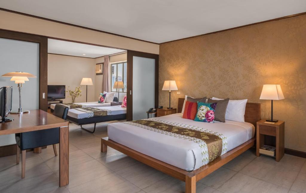 Postel nebo postele na pokoji v ubytování Hotel Kimberly Manila