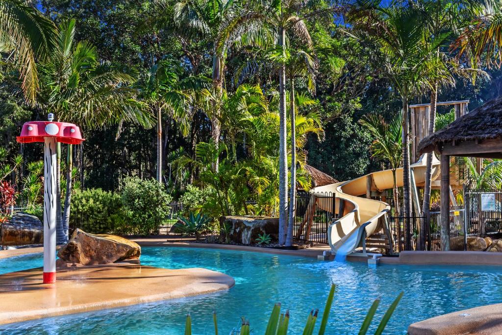a swimming pool with a slide in a resort at BIG4 Bays Holiday Park in Anna Bay