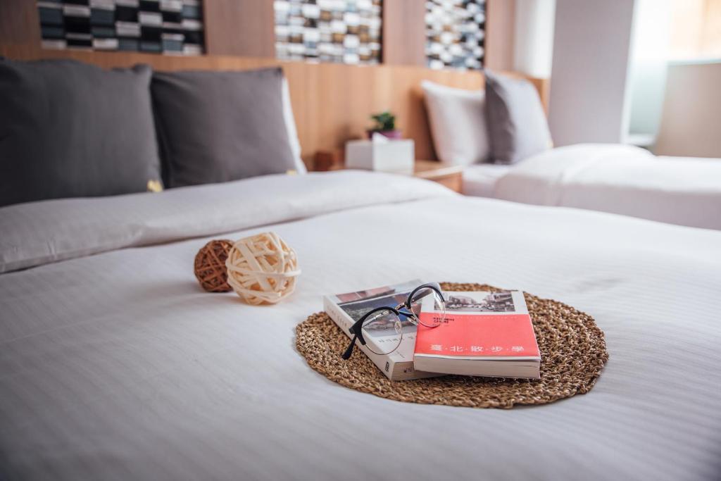 Postel nebo postele na pokoji v ubytování Muzik Hotel - Ximending Xining Branch