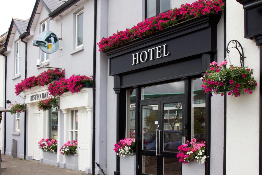 a hotel with flowers on the front of a building at The Huntsman Inn in Galway