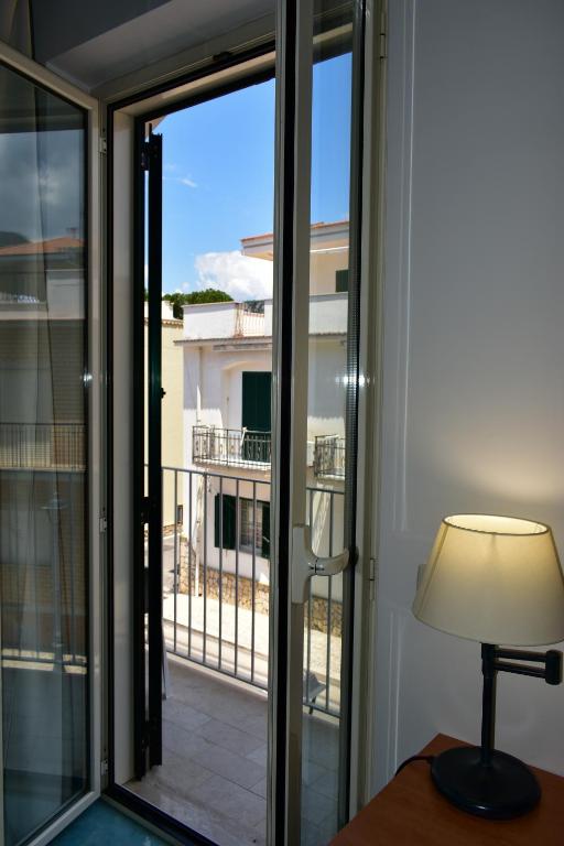 a sliding glass door with a view of a balcony at Hotel Amyclae in Sperlonga