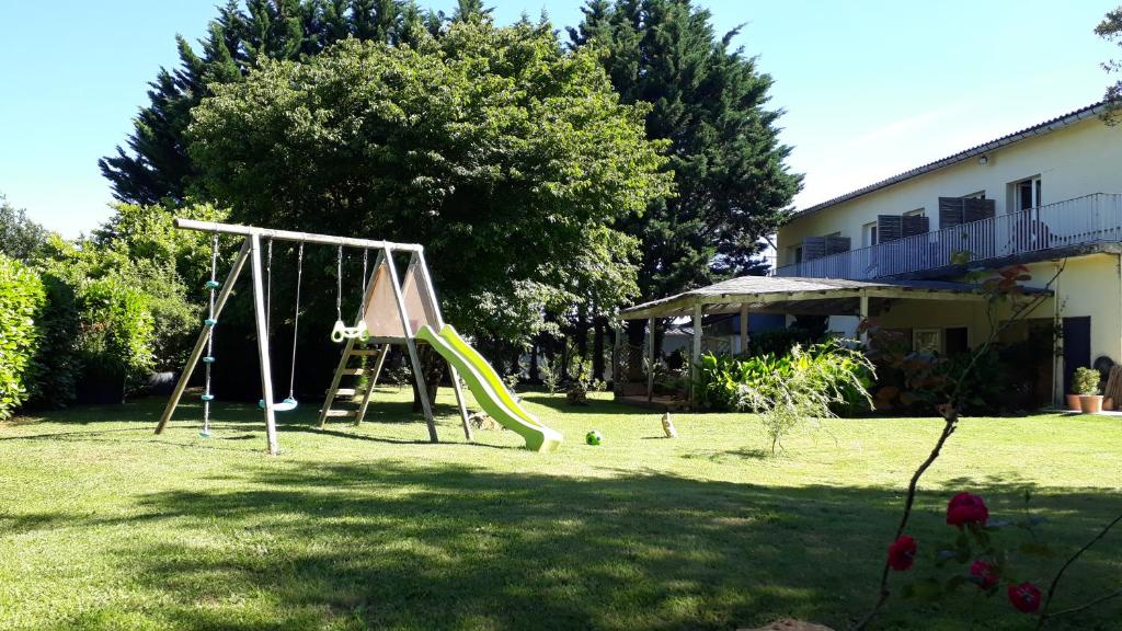 un parco giochi con scivolo in un cortile di Logis Hôtel Restaurant La Borie a Saint-Geniès