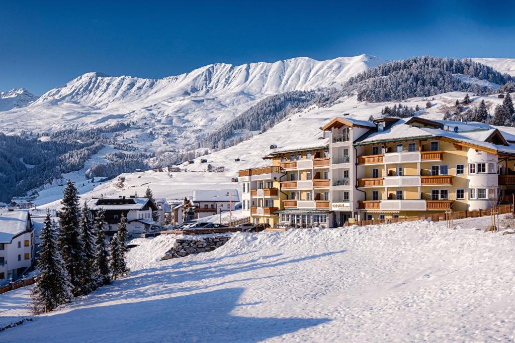 a hotel on a snowy mountain with snow covered mountains at Hotel Castel - pure Lebensfreude in Serfaus