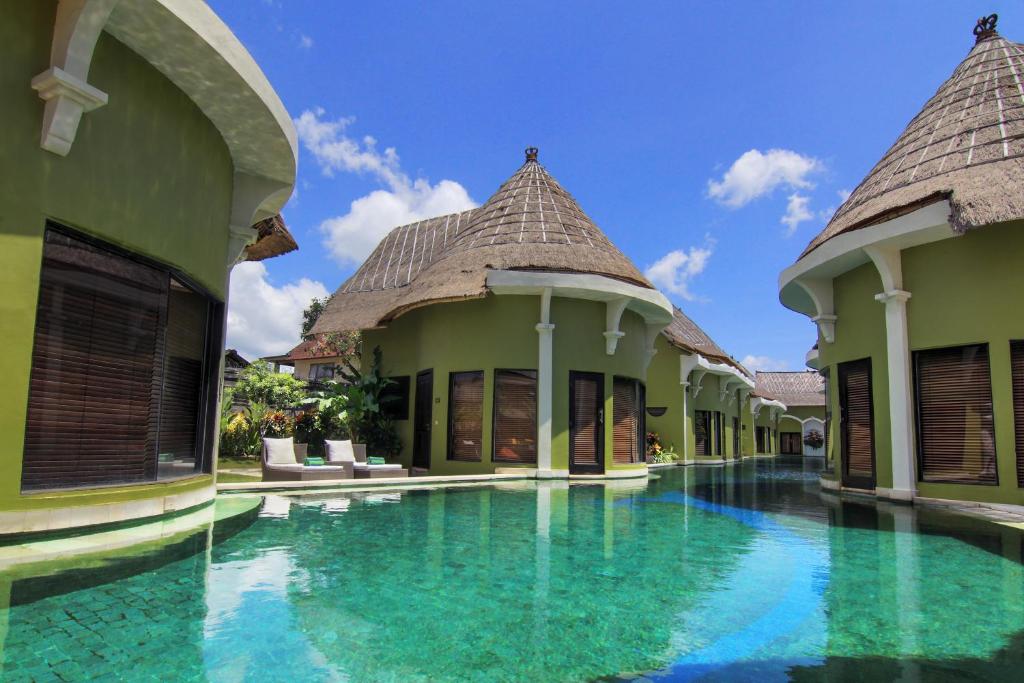 a swimming pool in the courtyard of a villa at Villa Seminyak Estate & Spa - By Astadala in Seminyak