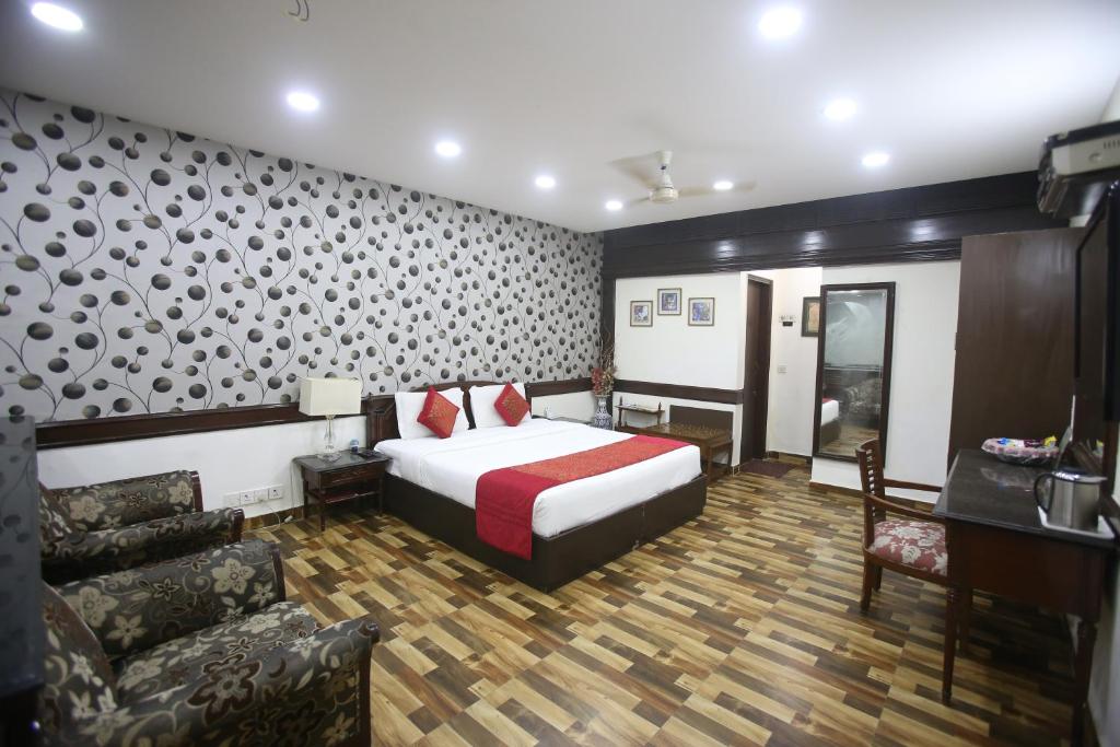 Rúm í herbergi á Hotel Amar Inn- Lajpat Nagar Central Market