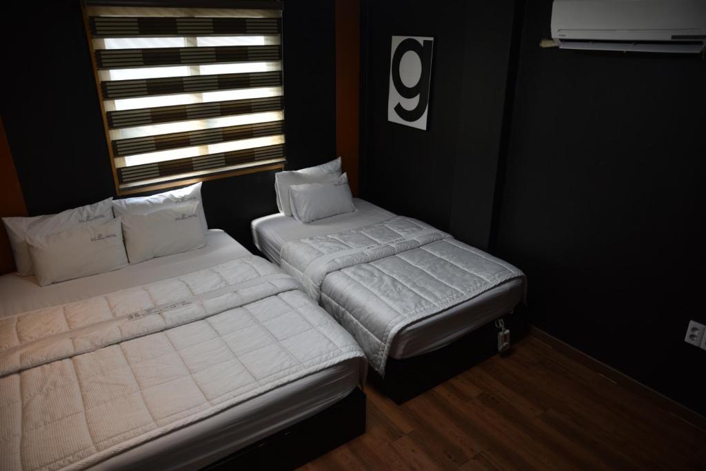 Postel nebo postele na pokoji v ubytování Business Hotel Busan Station