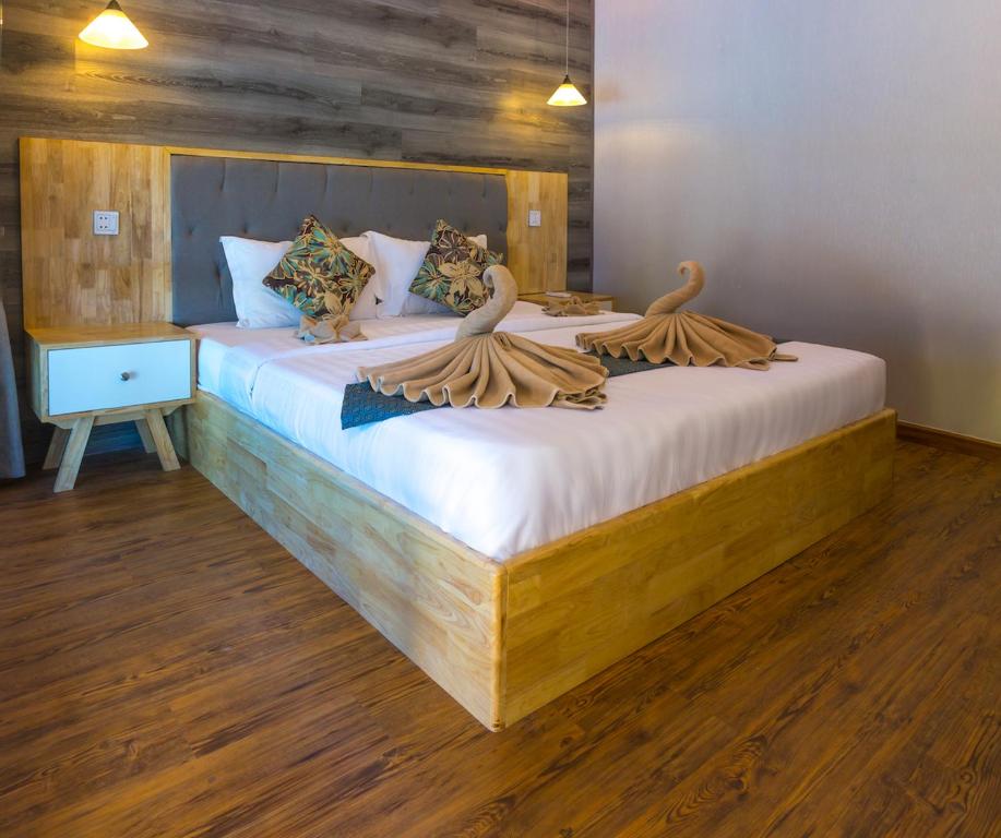a bedroom with two beds with towels on them at Sara Resort in Koh Rong Sanloem