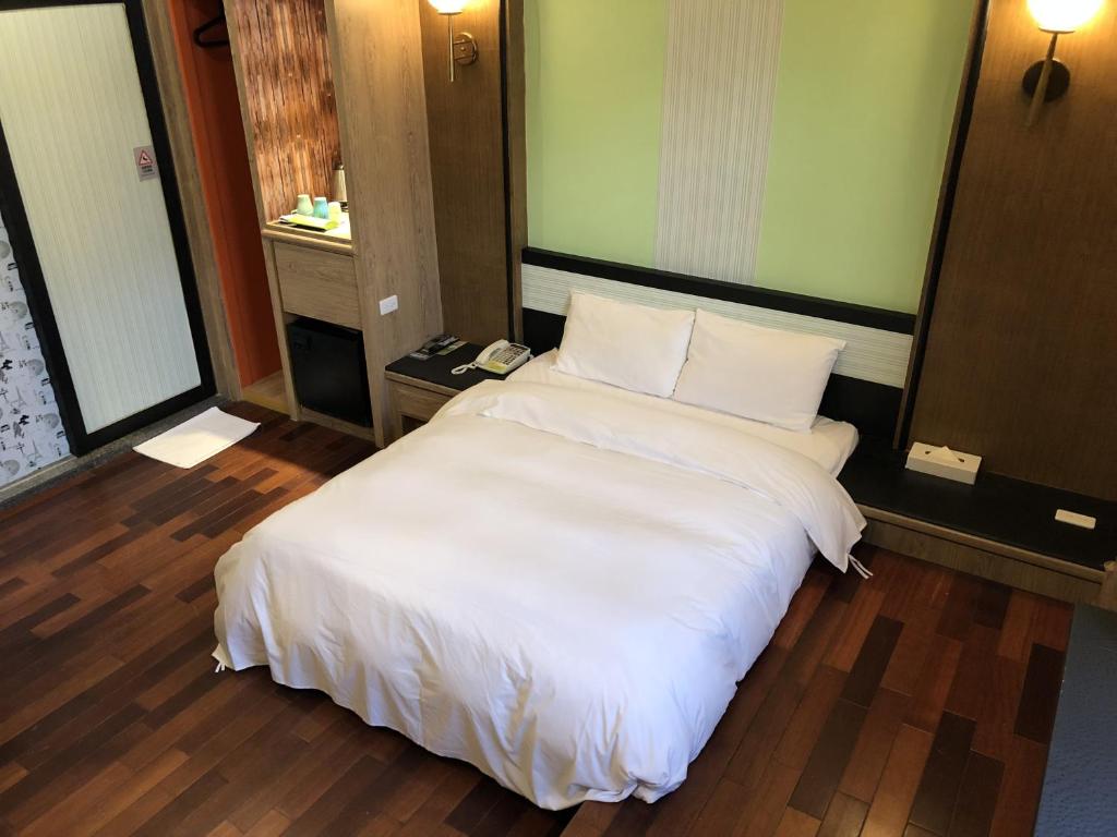 Postel nebo postele na pokoji v ubytování Guest Motel-Zhubei