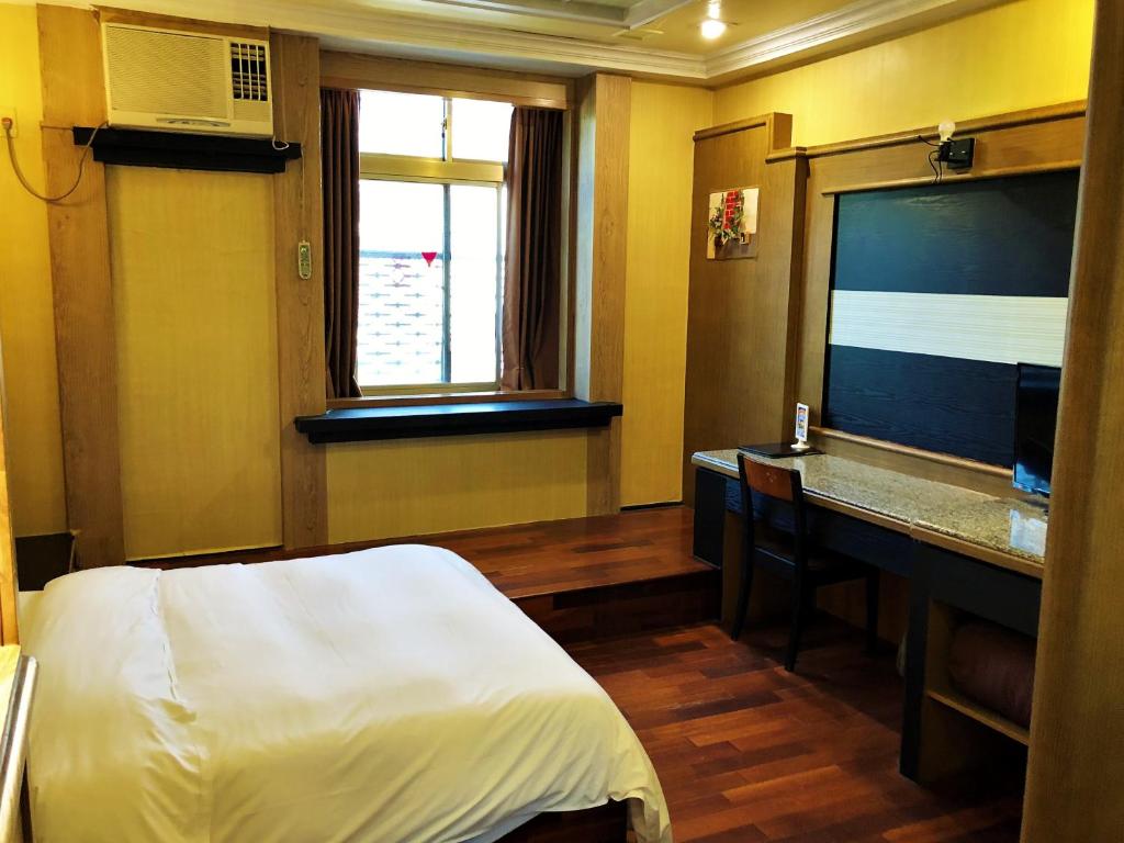 Postel nebo postele na pokoji v ubytování Guest Motel-Zhubei