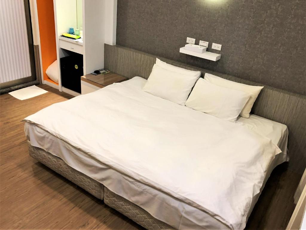 Postel nebo postele na pokoji v ubytování Guest Motel-Zhubei