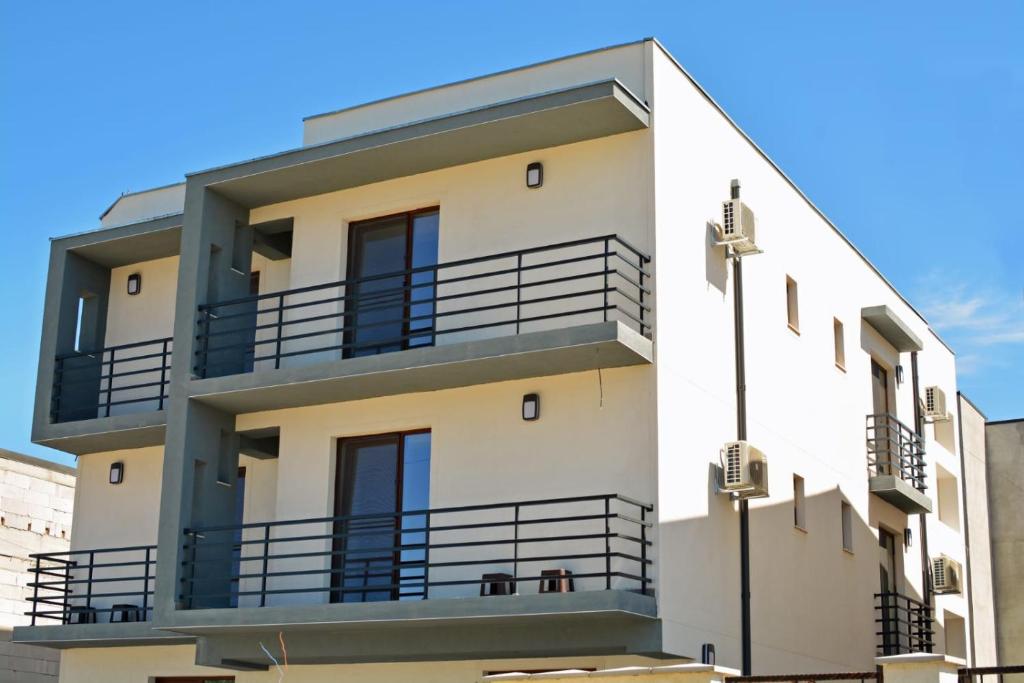 a building with balconies on the side of it at Vila La Matache in Eforie Nord
