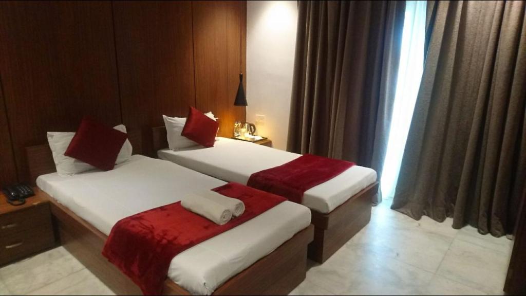Postel nebo postele na pokoji v ubytování Tatvam Residency