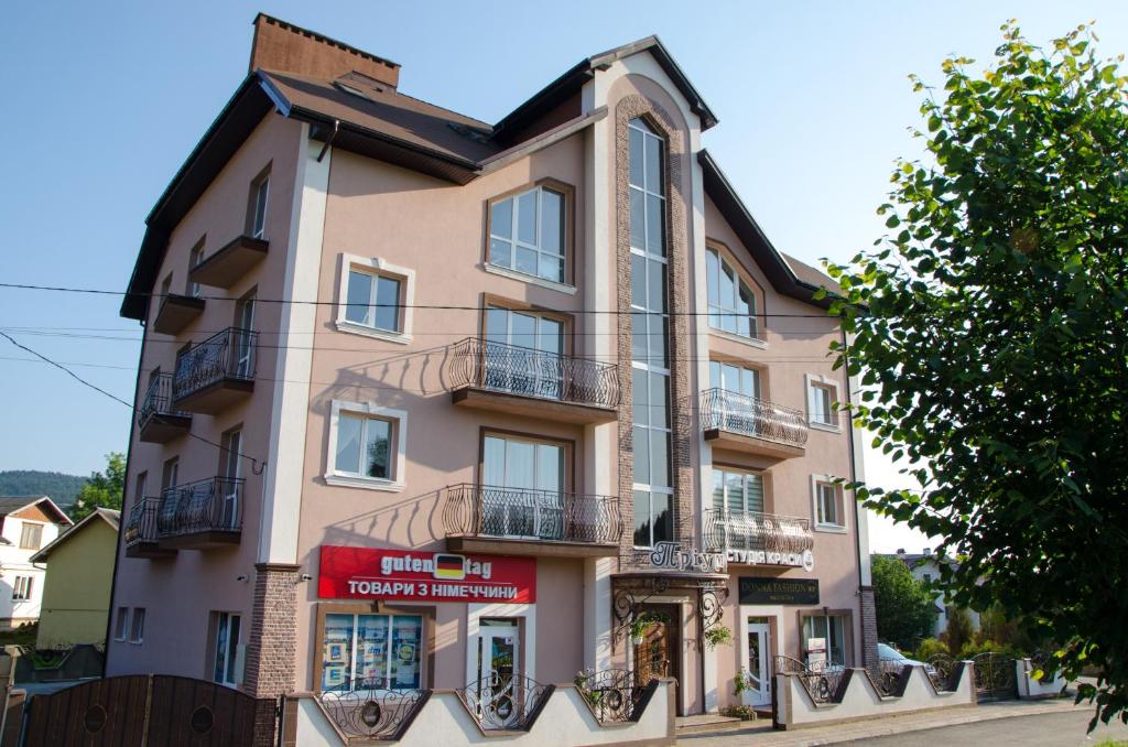 a tall building with balconies on a street at Triumph in Skhidnitsa