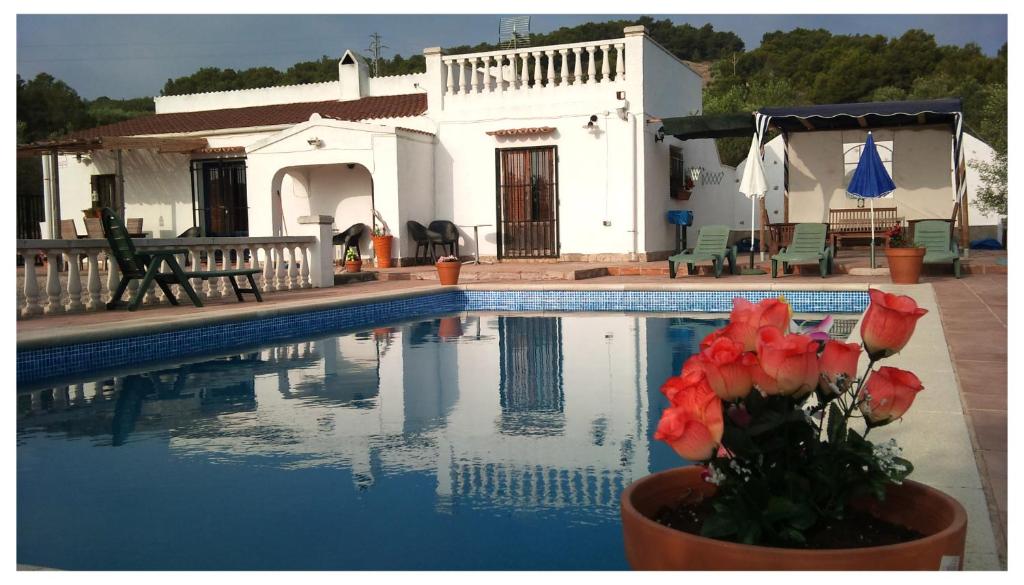 a house and a swimming pool with a house at Casa Olivo in Perelló