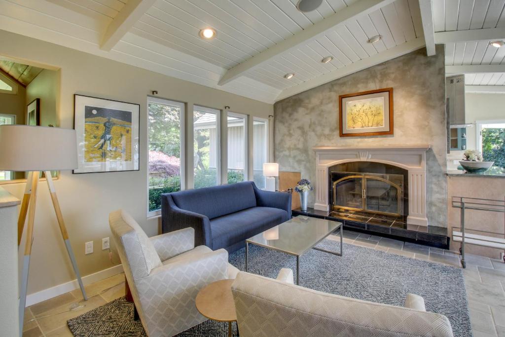 a living room with a blue couch and a fireplace at Sills Bluff Sunset Vista in Clinton