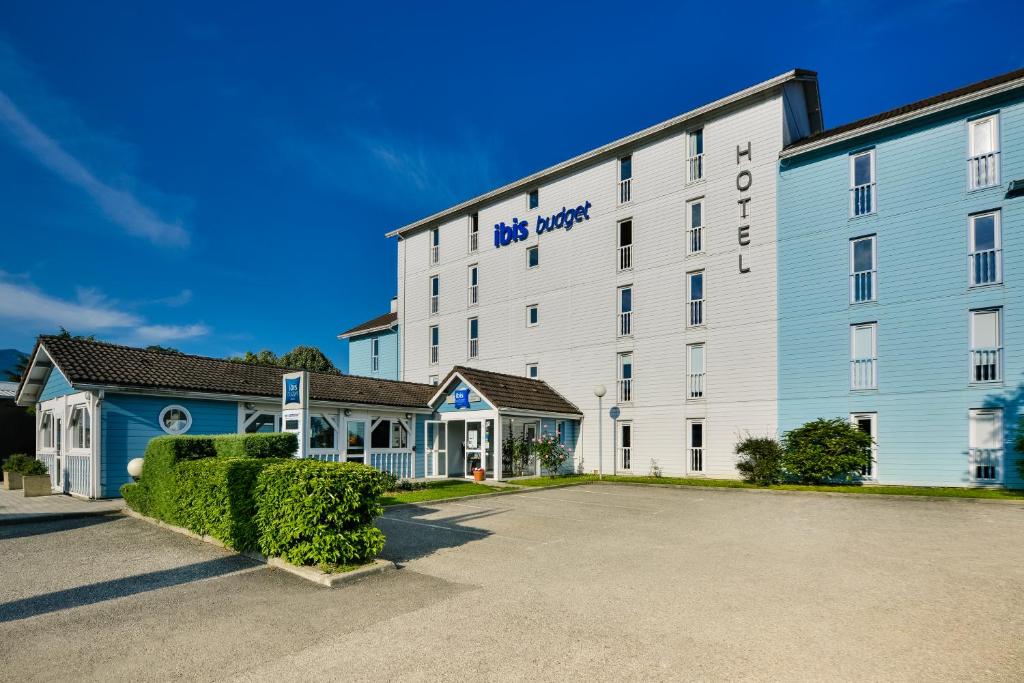 a large white house with a large window at Ibis budget Chambéry Centre Ville in Chambéry