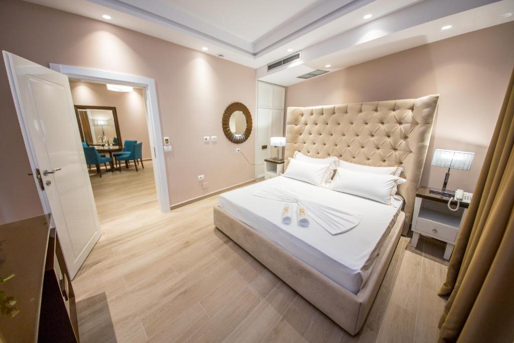 a bedroom with a large bed with a large headboard at Sole Luna Hotel in Borsh