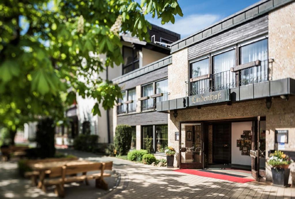 a building with two benches in front of it at Hotel Lindenhof Hubmersberg in Pommelsbrunn