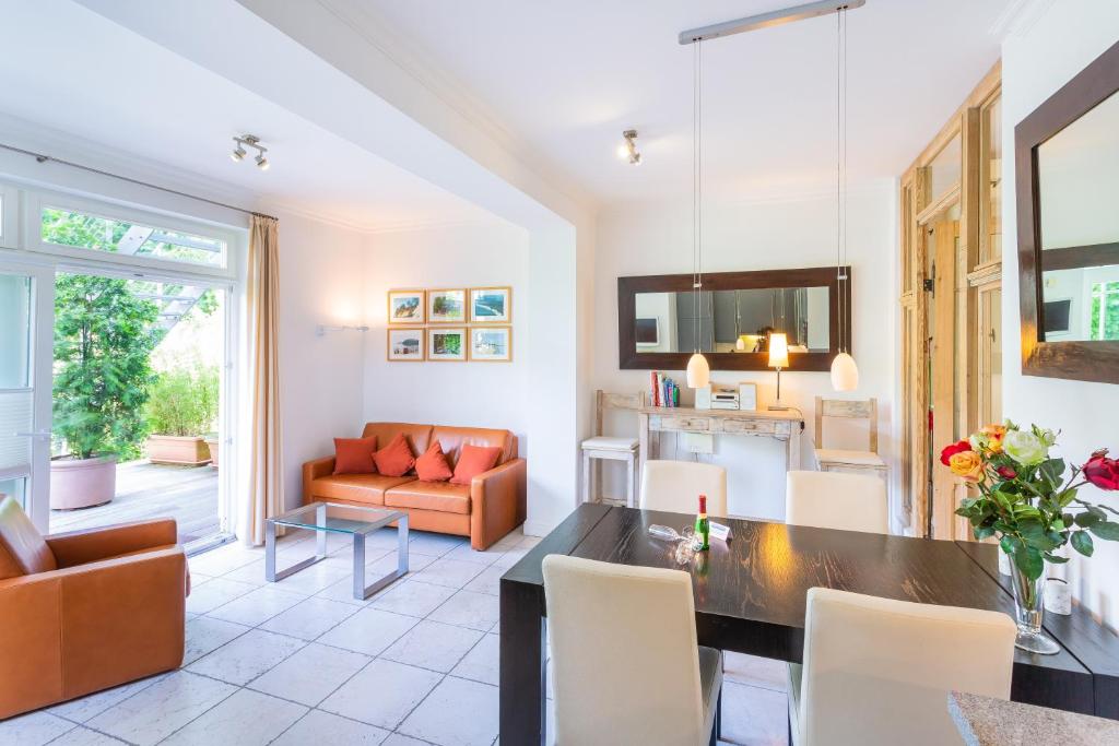 a living room with a couch and a table at Villa Ravensberg in Binz