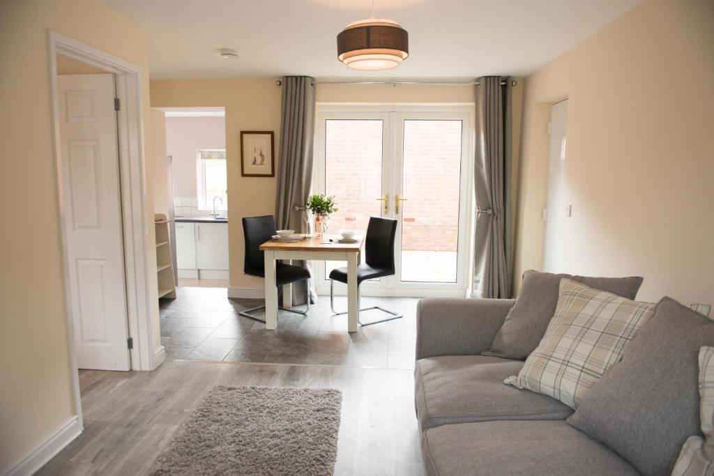 a living room with a couch and a table at Orchard View in Worcester