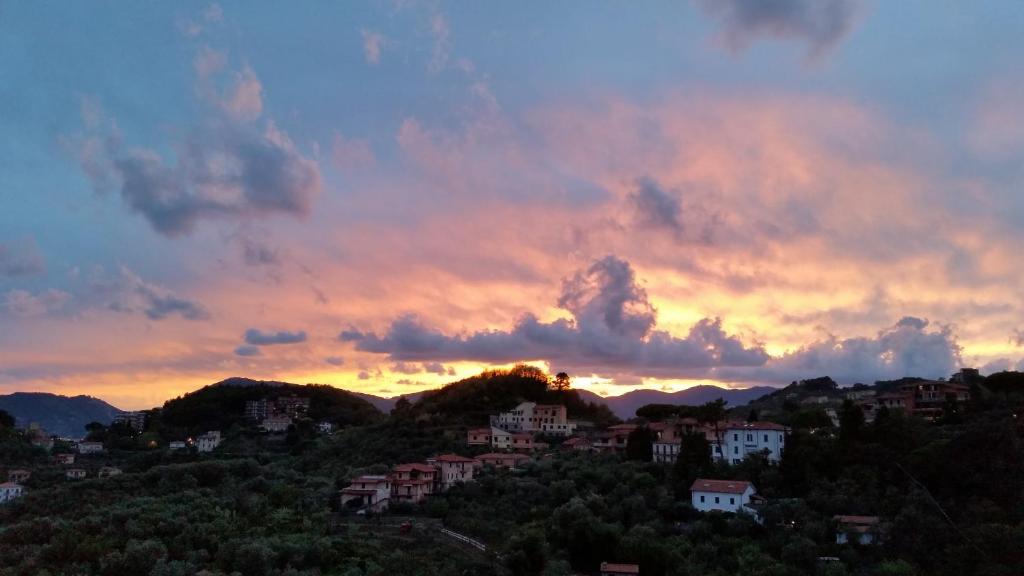 a sunset over a town on a hill at La Torretta in Lerici