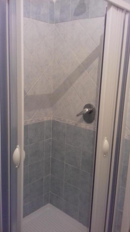 a shower with a glass door in a bathroom at Affittacamere da Rosa in Policastro Bussentino