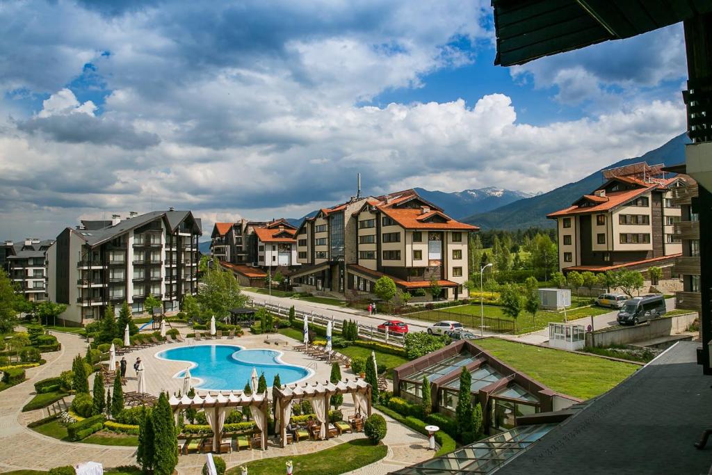 an apartment complex with a swimming pool and buildings at Aspen Golf and Ski Resort in Bansko