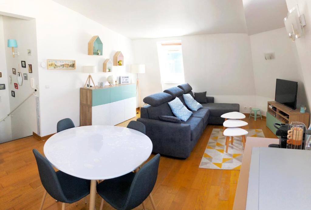 a living room with a table and a couch at Les quais de Trouville in Trouville-sur-Mer