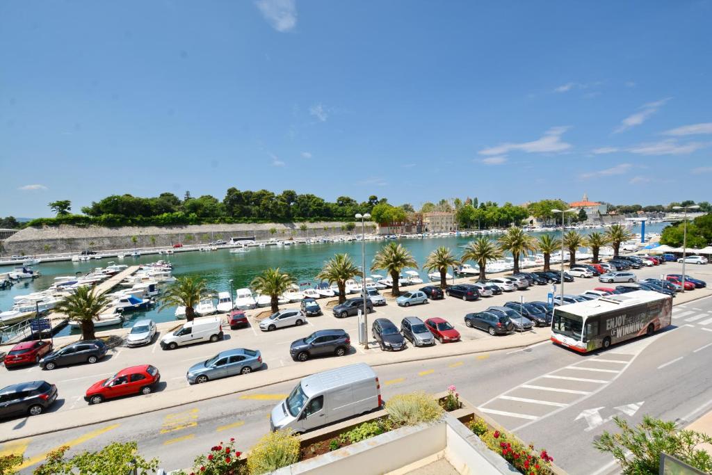 a parking lot with cars parked next to a marina at Spacious Premium Apt Lipotica with Oldtown view - Have a memorable holiday in Zadar