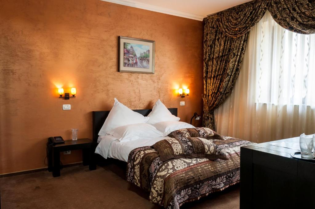 Postelja oz. postelje v sobi nastanitve Pensiune Turistica Tosca