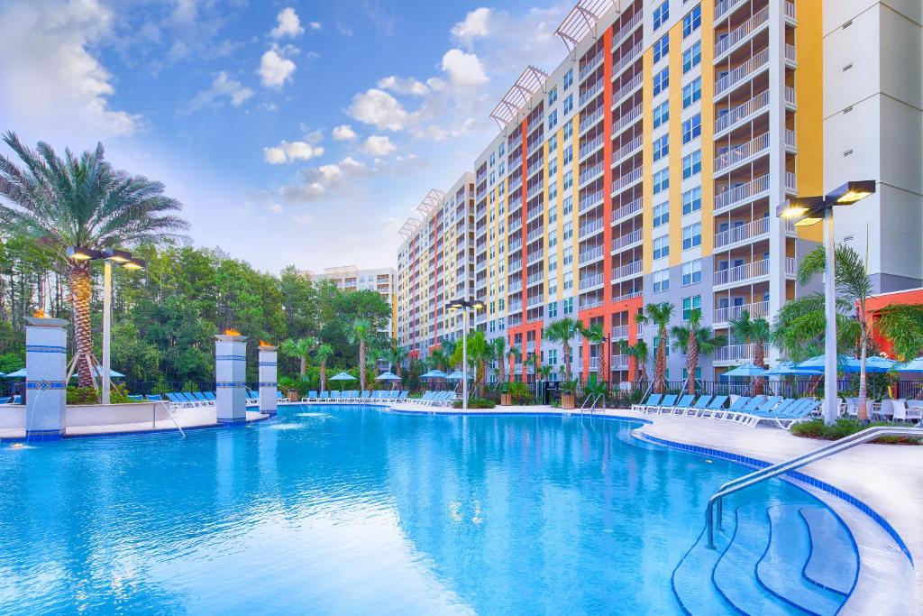 a large swimming pool in a resort with buildings at Vacation Village at Parkway in Orlando
