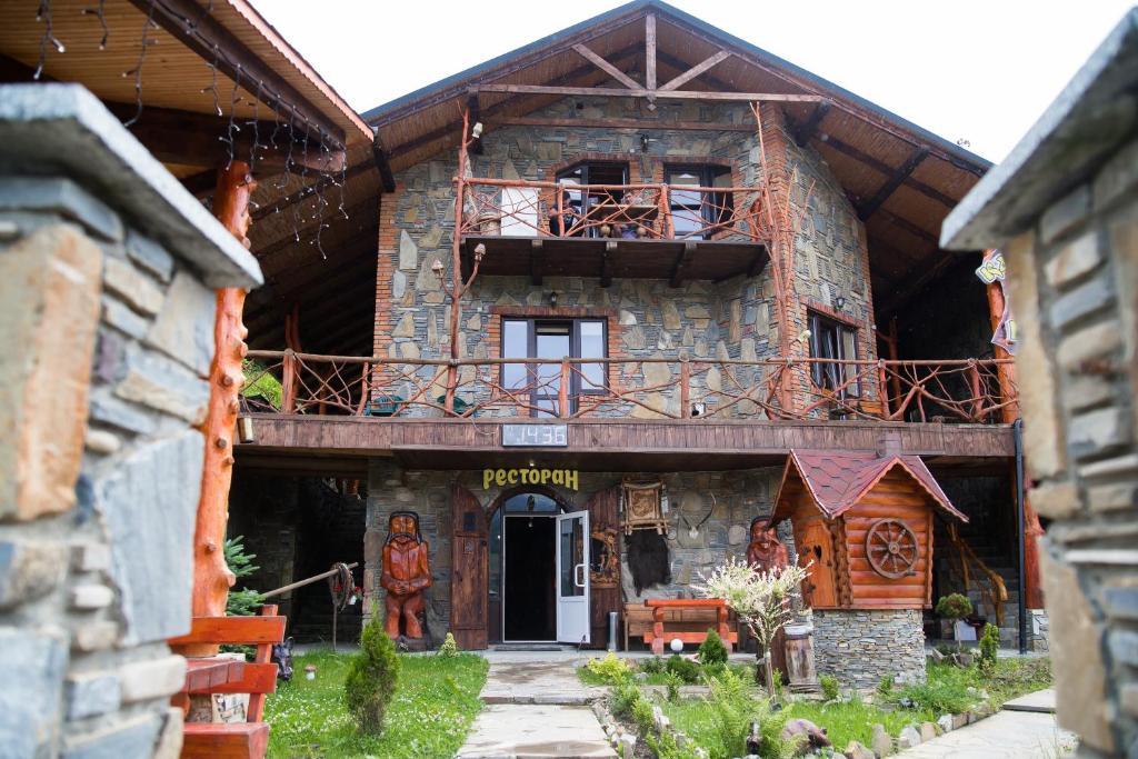 a large wooden building with a balcony on it at Kabanova Gora in Bukovel