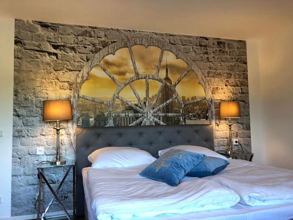 a bedroom with a large bed with a stone wall at Wondervolles zuhause auf Zeit in Moers