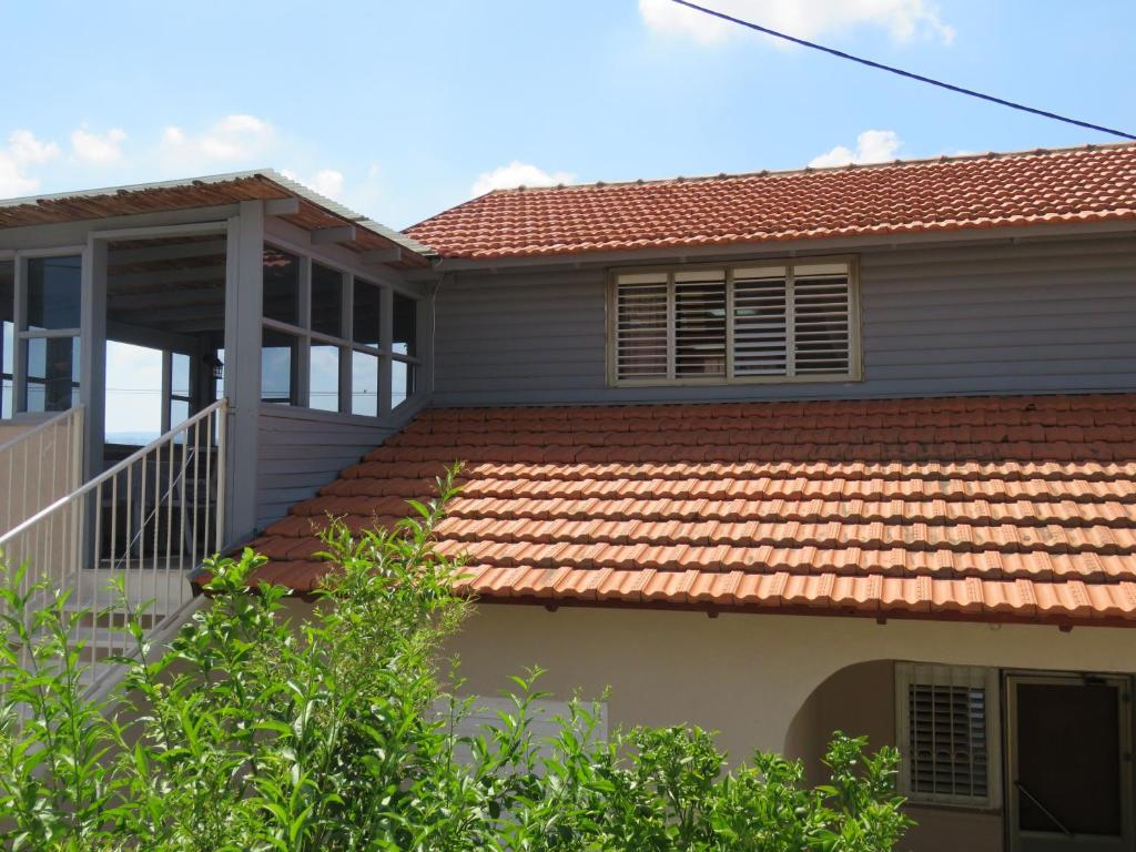 a house with a red tile roof at בין יער לים in Shlomi