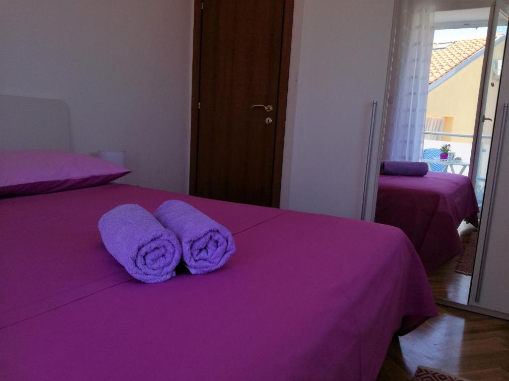Posteľ alebo postele v izbe v ubytovaní Apartments Bellus Mare