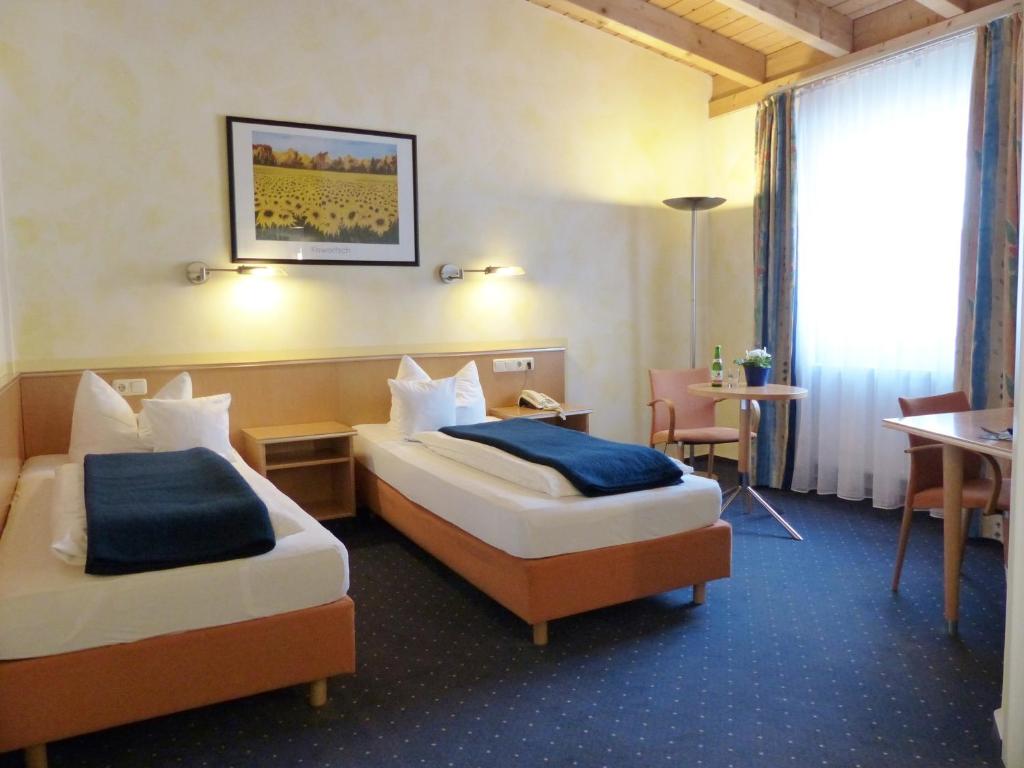 En eller flere senger på et rom på Grimmelshausen Hotel