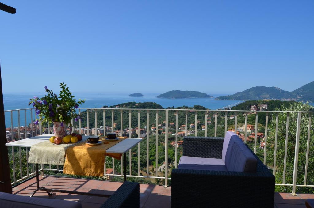 a balcony with a table and chairs and a view of the city at LA CASTELLANA Una Finestra sul Mare- Air Conditioned in Lerici