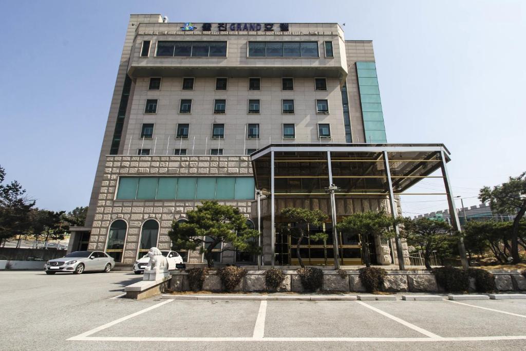 a building with a parking lot in front of it at Uljin Grand Hotel in Uljin