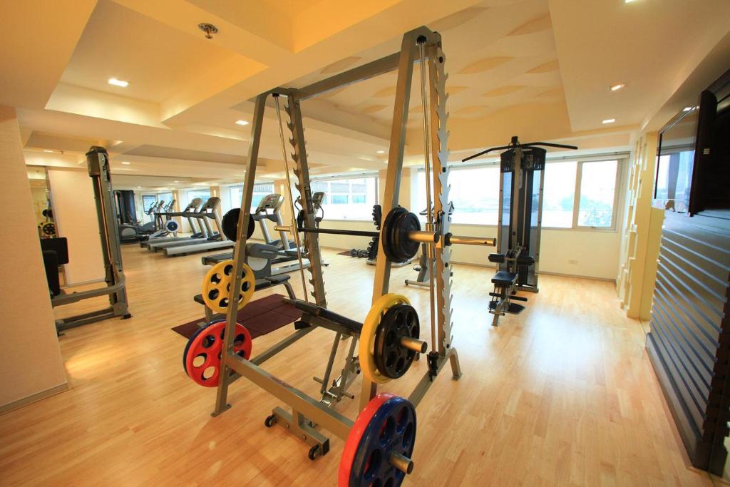 A weight-training area with a power rack, cable machines and cardio equipment.