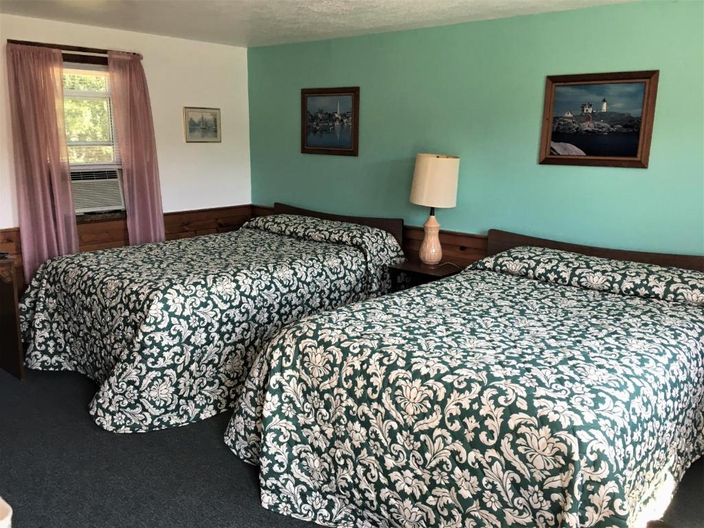 a hotel room with two beds and a window at Bass River Motel in South Yarmouth