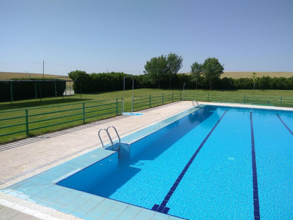a large swimming pool with blue water at Casa Rural Isabel in Villaflores