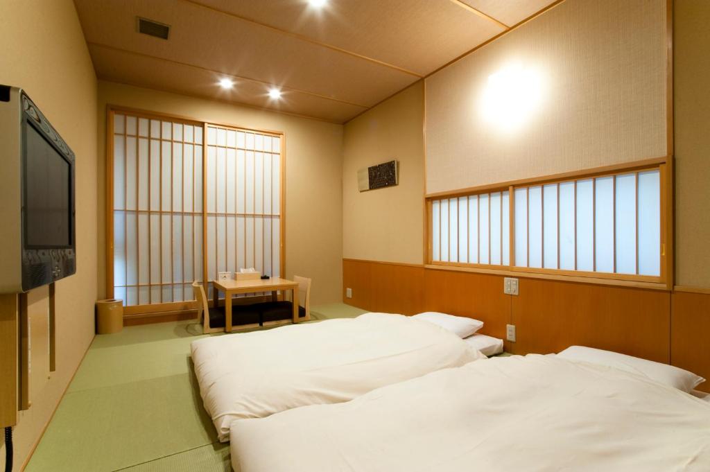 Postel nebo postele na pokoji v ubytování Ochanomizu Hotel Shoryukan