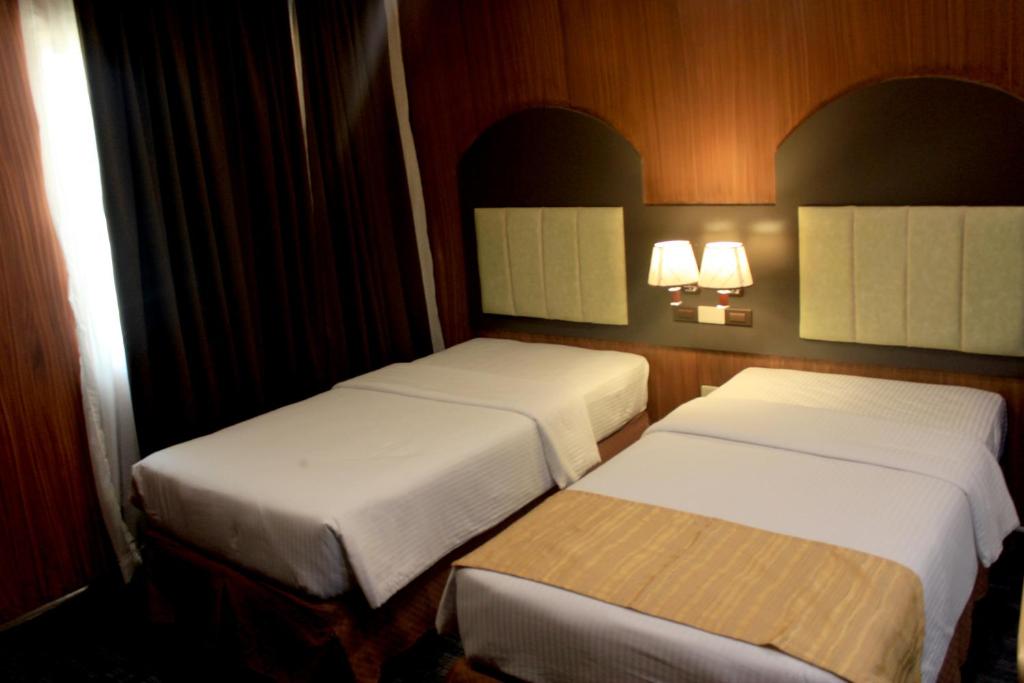 Postel nebo postele na pokoji v ubytování Butuan Grand Palace Hotel