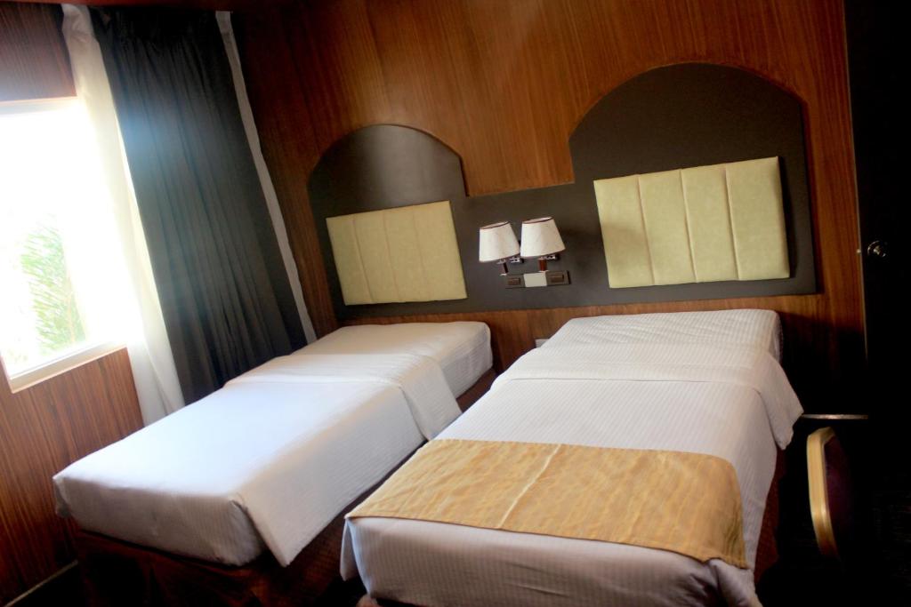 Postel nebo postele na pokoji v ubytování Butuan Grand Palace Hotel
