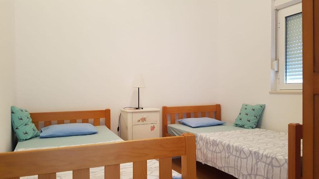 Postel nebo postele na pokoji v ubytování Apartment Dario